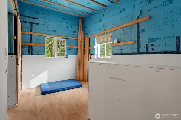 a view of a room with wooden floor and windows