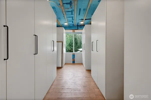 a view of a hallway with wooden shelves