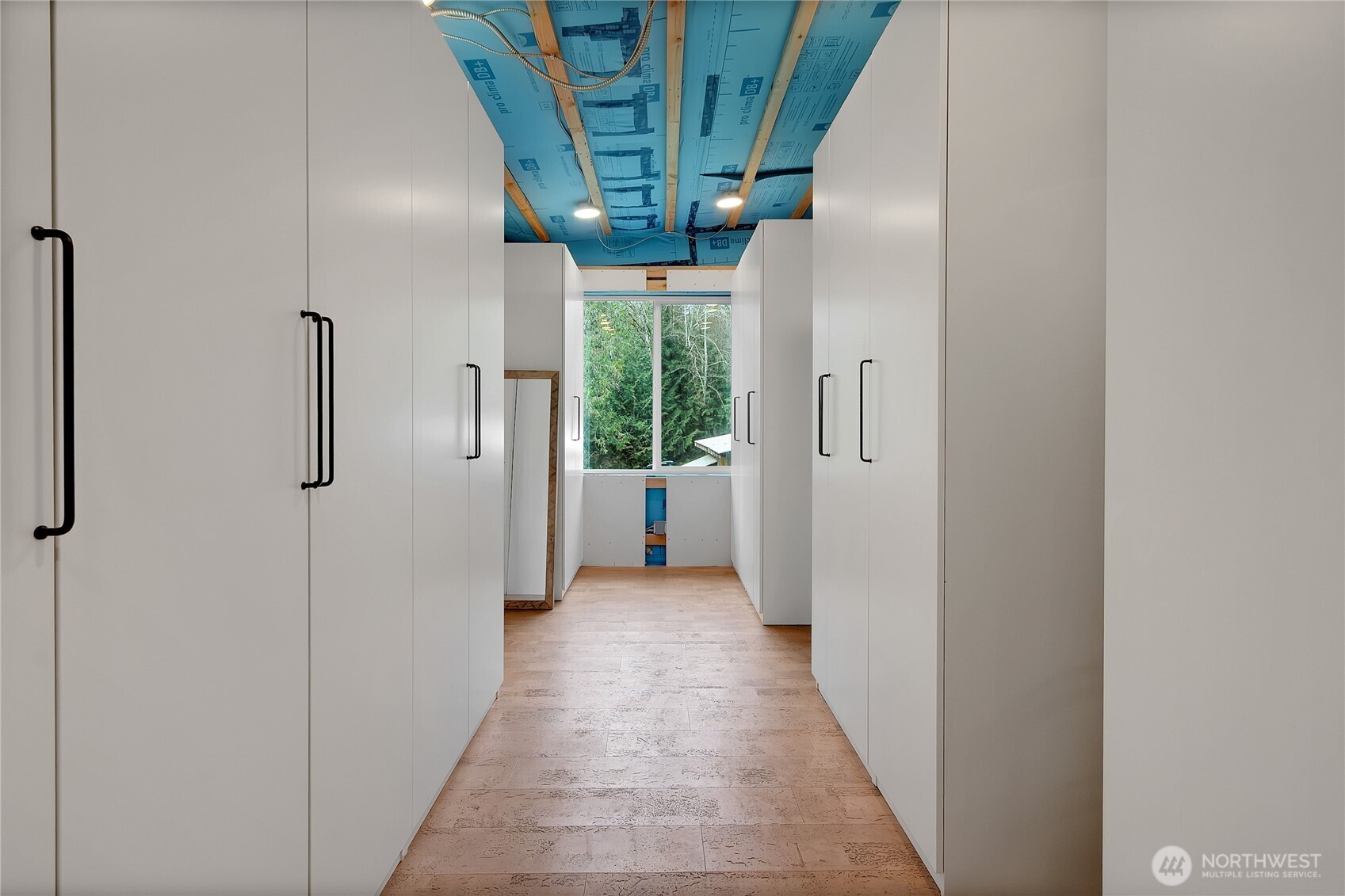 17410 68th Street Northwest Vaughn, WA 98394 - Photo 16 of 24 a view of a hallway with wooden shelves