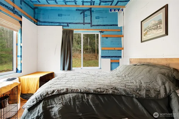 a bedroom with a bed and window