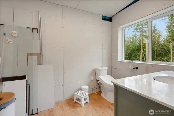a bathroom with a sink a toilet and a window