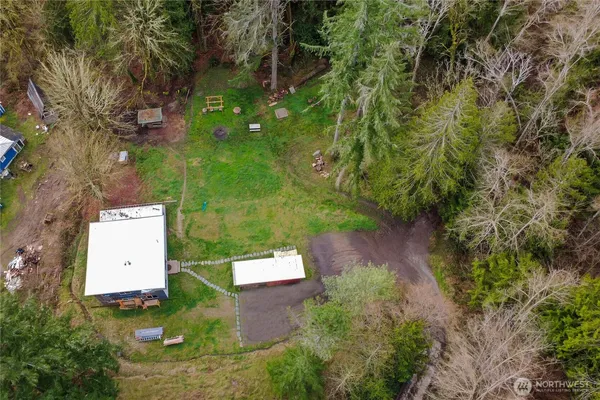 an aerial view of a house with a yard