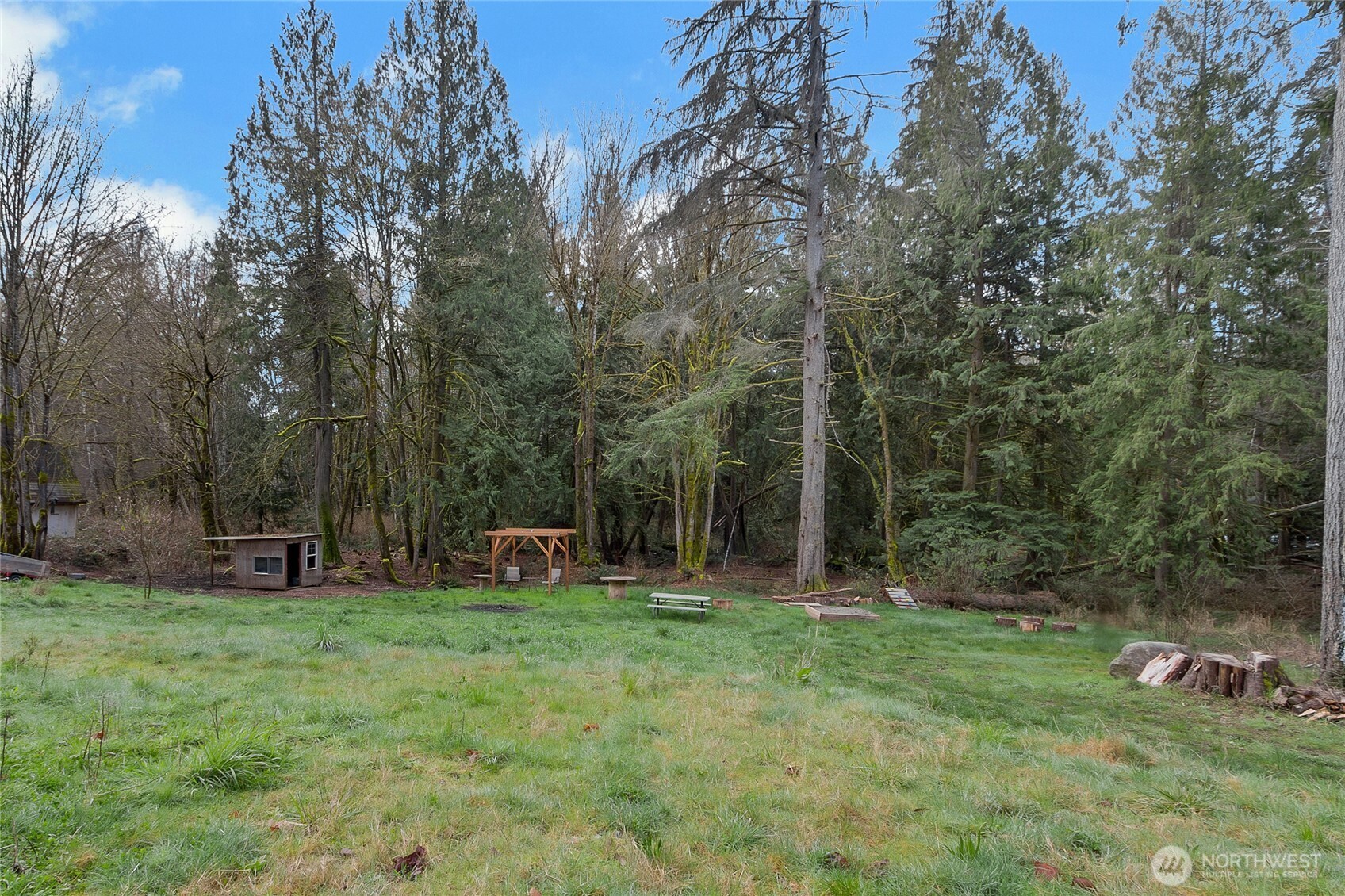 17410 68th Street Northwest Vaughn, WA 98394 - Photo 22 of 24 a backyard of a house with barbeque oven and yard
