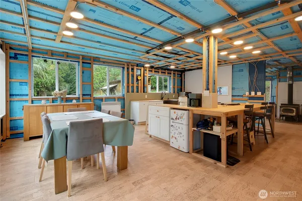 a view of a kitchen with kitchen island a table and chairs in it