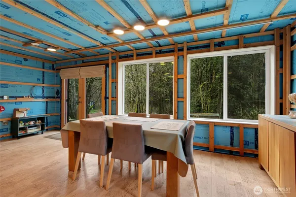 a view of a dining room with furniture large windows and wooden floor
