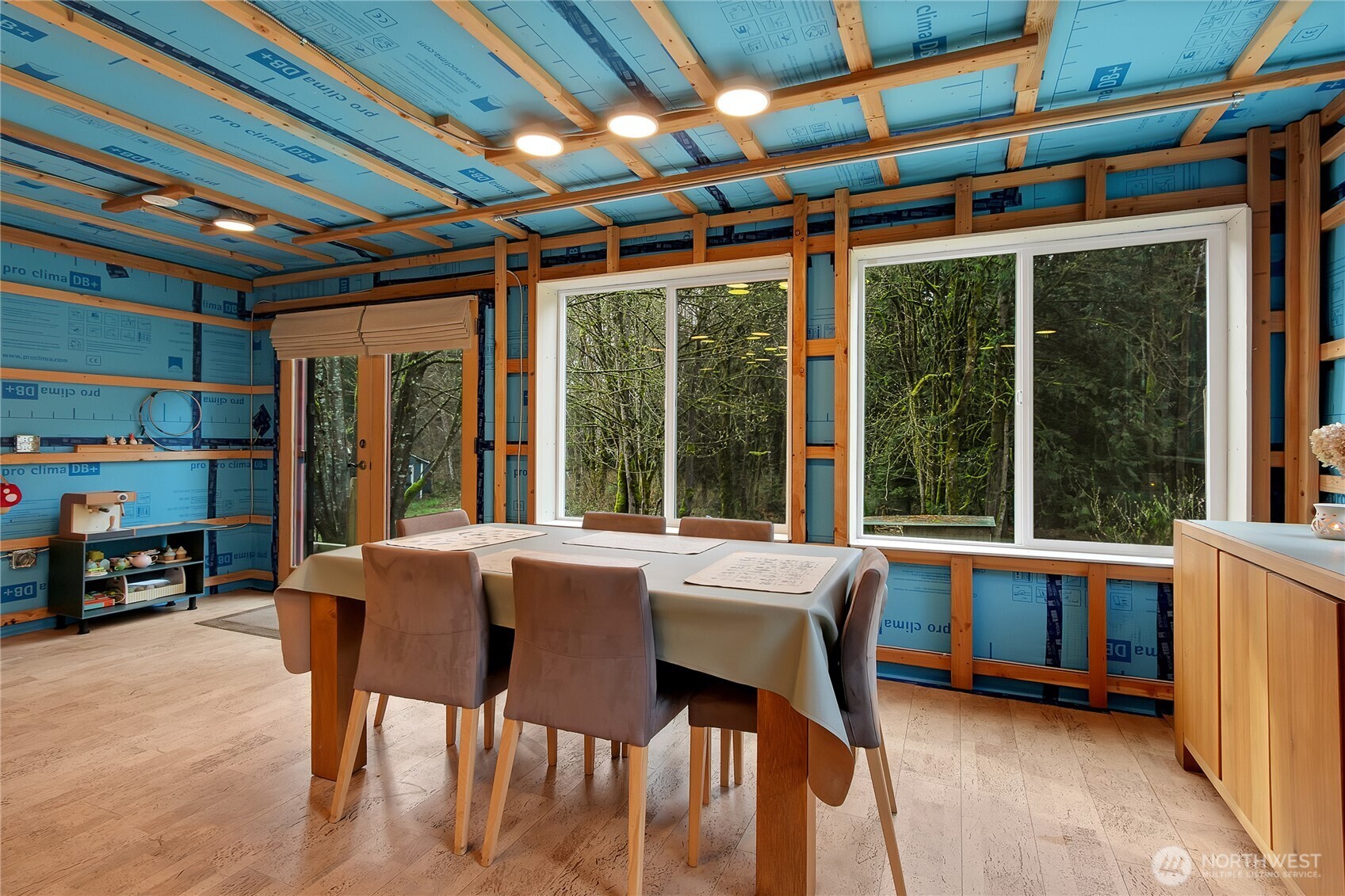 17410 68th Street Northwest Vaughn, WA 98394 - Photo 5 of 24 a view of a dining room with furniture large windows and wooden floor
