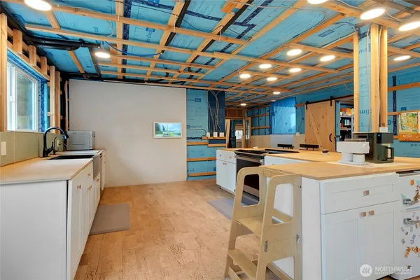 a kitchen that has a sink a stove and a refrigerator