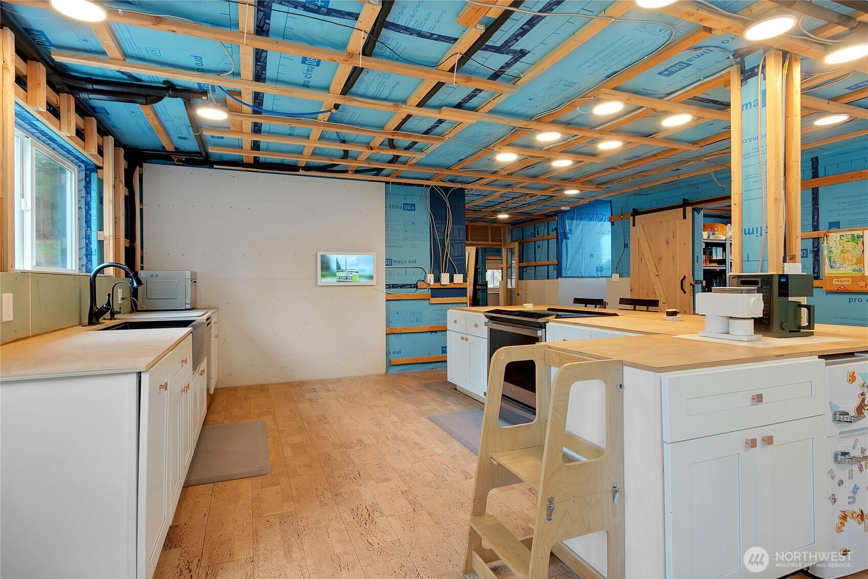 17410 68th Street Northwest Vaughn, WA 98394 - Photo 6 of 24 a kitchen that has a sink a stove and a refrigerator