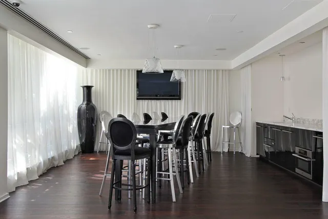 a view of a patio with couches and table and chairs and potted plants