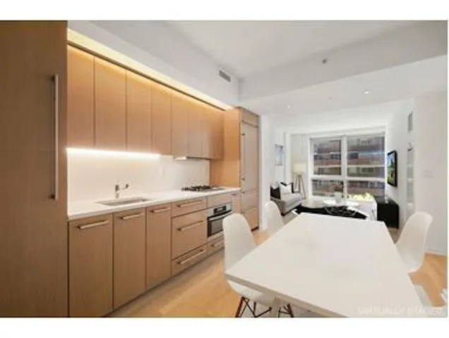 a kitchen with granite countertop a stove a sink and a microwave