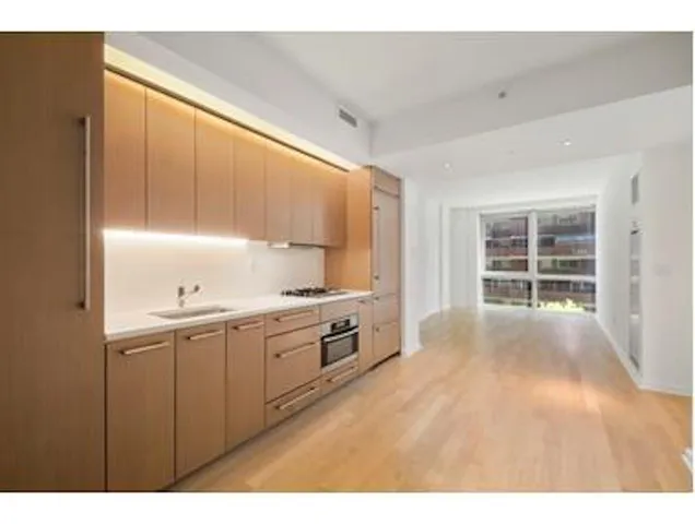 a kitchen with granite countertop a stove a sink and a microwave