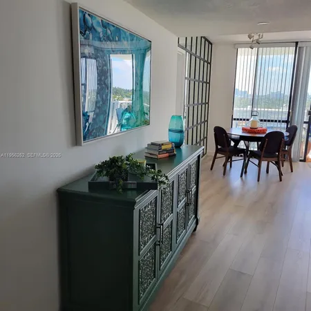 a living room with furniture wooden floor and a large window