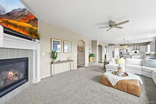 a living room with furniture a fireplace and a flat screen tv