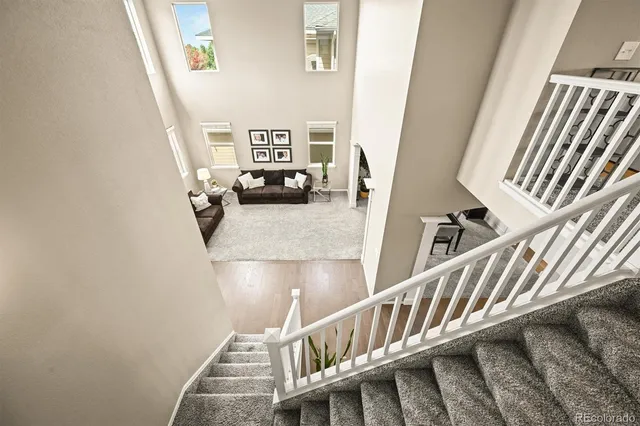 a living room with a fireplace and a potted plant