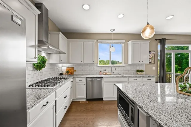 a kitchen with stove cabinets and a window