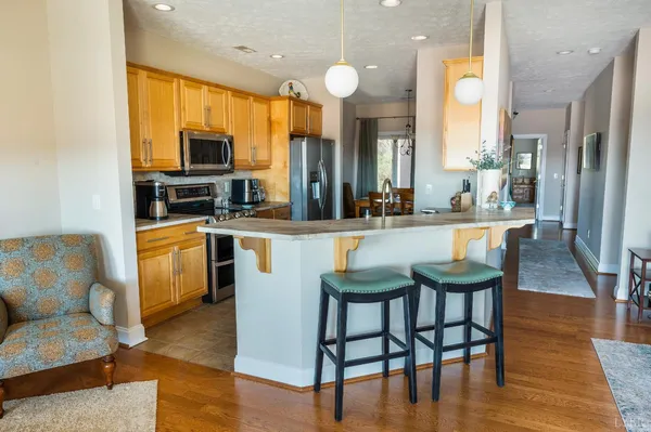 a kitchen with stainless steel appliances a stove a sink and a refrigerator