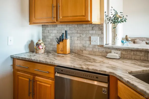 a kitchen with stainless steel appliances granite countertop a stove a refrigerator and a cabinets