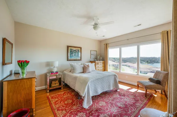 a bedroom with a large bed and a chandelier