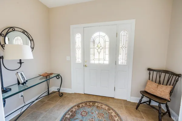 a view of a room with gym equipment and wooden floor