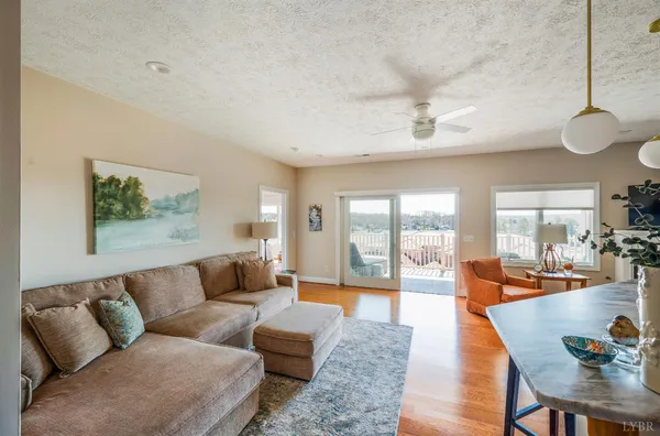 a living room with furniture and view of kitchen