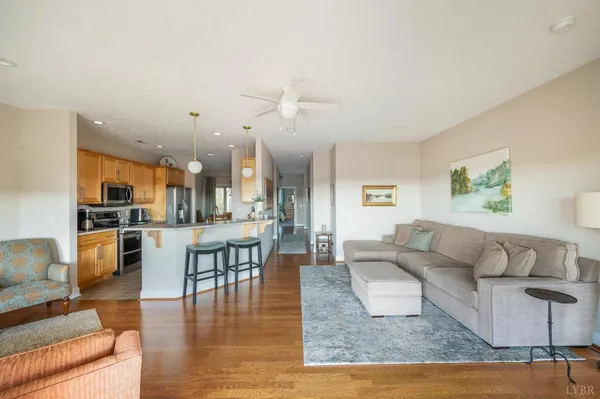 a living room with furniture and a wooden floor