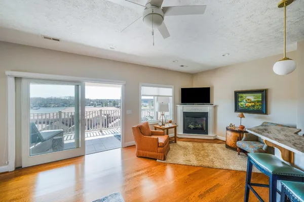 a living room with furniture a fireplace and a flat screen tv