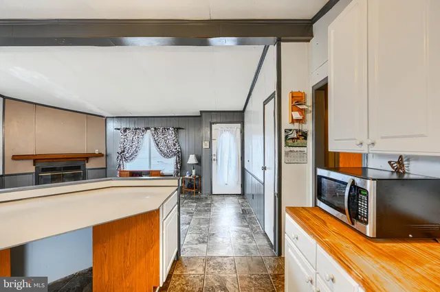 a kitchen with a sink appliances and cabinets