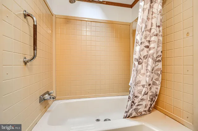 a bathroom with a toilet and a shower curtain