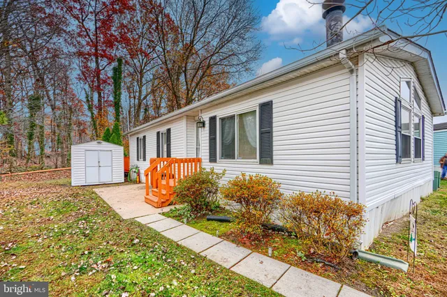a front view of a house with a yard and outdoor seating