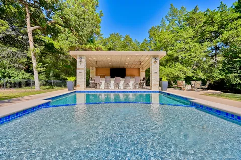 a view of swimming pool with an outdoor seating