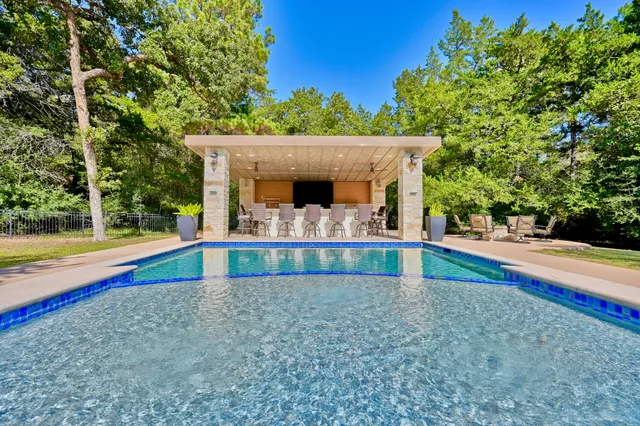 a view of swimming pool with an outdoor seating