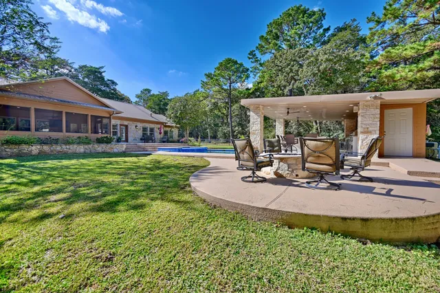 a view of a house with backyard and sitting area