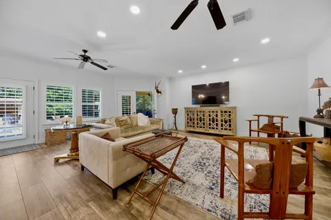 a living room with furniture ceiling fan and a rug