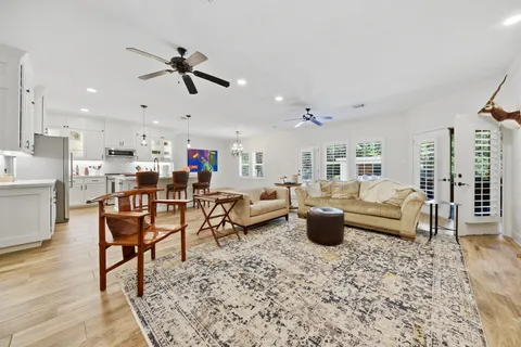 a living room with furniture and kitchen view