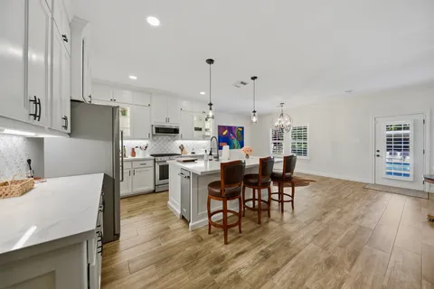 a kitchen with a sink appliances and cabinets