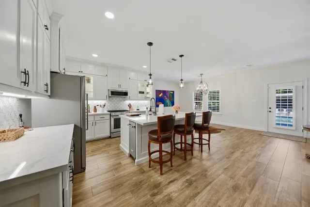 a kitchen with a sink appliances and cabinets