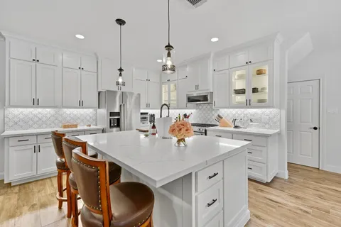 a view of a hallway with a couch and chandelier