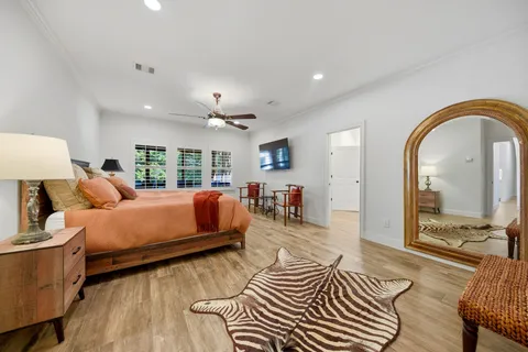a spacious bathroom with a double vanity sink a large mirror and shower