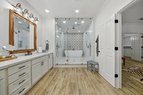 a spacious bathroom with double vanity and a shower