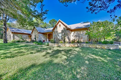 a front view of house with yard and green space