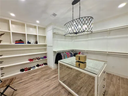 a bed room with a bed and a chandelier