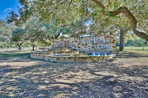 a view of a park with large trees