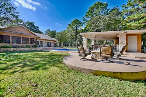 a view of a house with backyard porch and sitting area