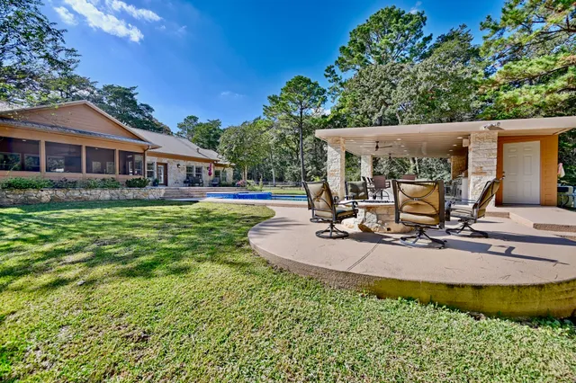 a view of a house with backyard porch and sitting area