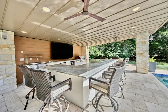 a view of a patio with furniture and a potted plant