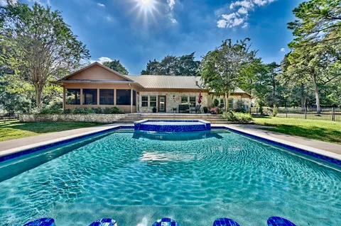 a front view of house with yard and outdoor seating