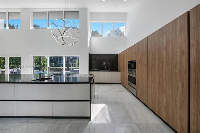 a spacious bedroom with a large bed and a flat screen tv