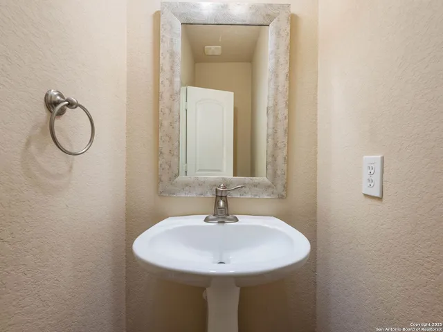 a living room with bed furniture and a large window