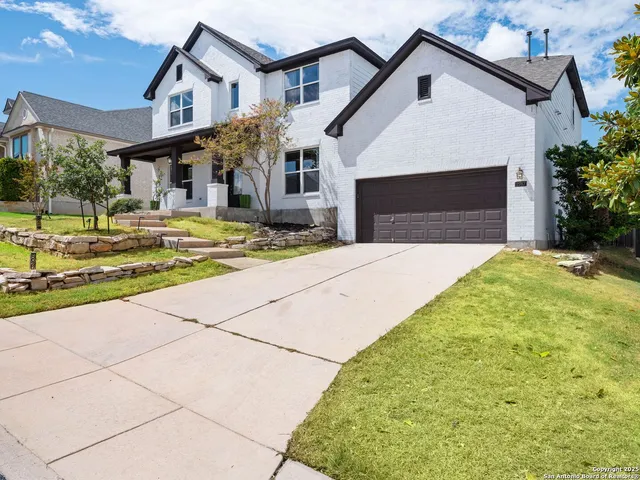 a front view of a house with a yard garage and outdoor seating