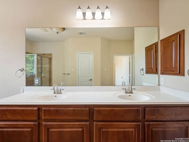 a bathroom with a tub sink and mirror
